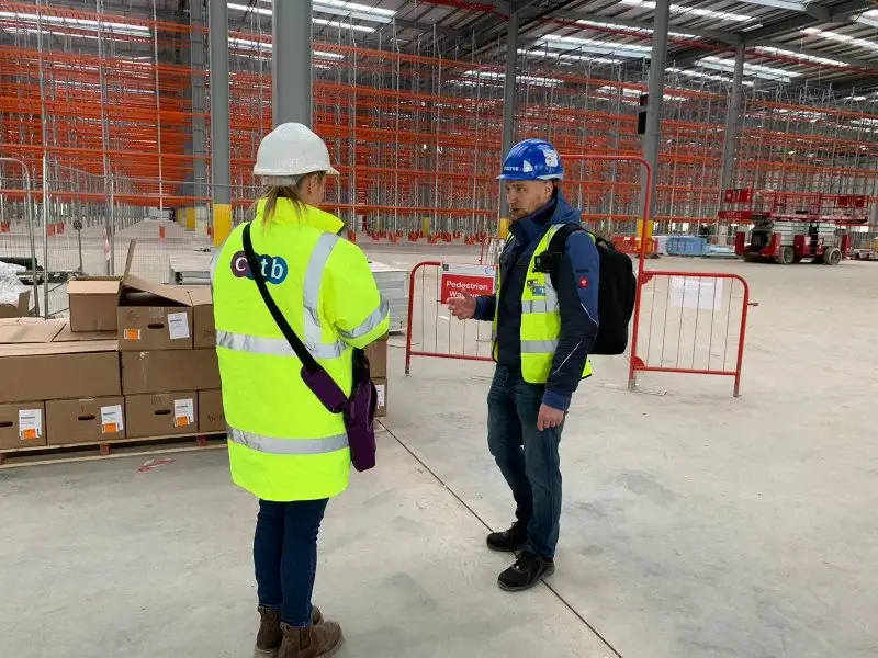 A CITB adviser meeting an Up Level assessor on a construction site during a standards verification visit