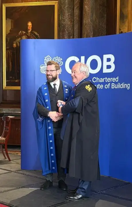 An Up Level assessor at a professional construction qualification graduation