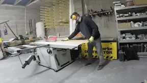 Bench carpenter using bench saw in the workshop