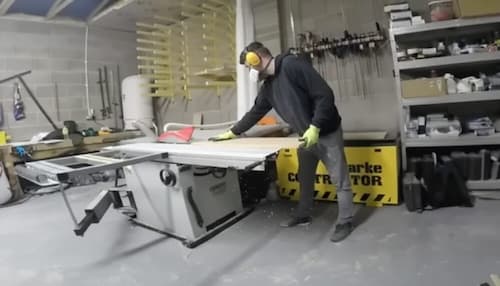 Bench carpenter using bench saw in the workshop