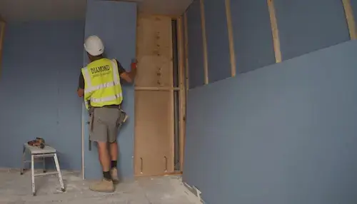 Boarding and Tacking NVQ Level 2 operative working on site