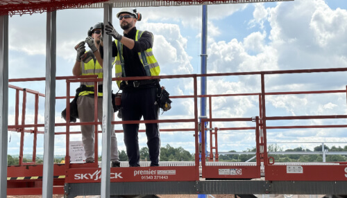 Two operatives installing SFS, metsec system in the workplace