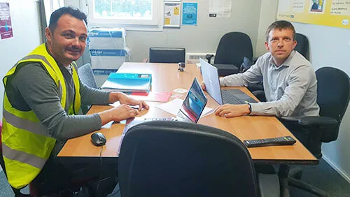 NVQ Level 6 contracts managers at the desk having a meeting