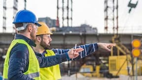 Two supervisors discuss instructions and provide guidance