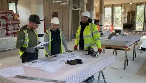 Contracts Supervisor NVQ Level 3 candidate reviewing contract documents on site