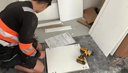 Fitted Interiors NVQ Level 2 furniture fitter installing kitchen units