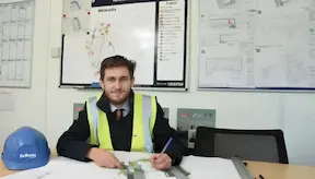Health & safety manager sitting at the managerial office desk