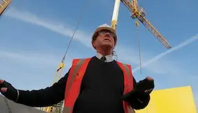 Construction senior manager standing under the crane on a construction site