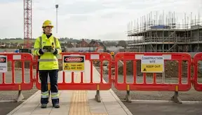 A woman senior site inspector standing on a construction site inspecting site conditions