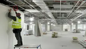 Ceiling fixer fixing Armstrong suspended ceiling system noggins around the perimeter